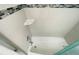 Bright bathroom featuring a white tiled bathtub and decorative tiled trim at 7076 Nichols St, Englewood, FL 34224