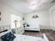 Bright bedroom with two beds, white furniture, and nautical-themed decor for a coastal vibe at 7076 Nichols St, Englewood, FL 34224