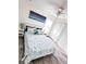 Inviting bedroom with ceiling fan, a queen bed, a nightstand, and a spacious closet at 7076 Nichols St, Englewood, FL 34224