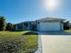 Charming single-story home with a well-maintained lawn and attached two-car garage at 7076 Nichols St, Englewood, FL 34224