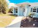 Inviting single-story home with a manicured front yard and charming walkway at 7076 Nichols St, Englewood, FL 34224