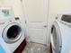 Functional laundry room featuring a washer, dryer, and storage space at 7076 Nichols St, Englewood, FL 34224