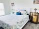 Comfortable bedroom with a white wooden bed frame, decorative pillows, and bedside tables at 7076 Nichols St, Englewood, FL 34224