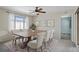 Dining room with decorative rug, large wooden table, and adjacent view of a bedroom at 7716 Vienna Ln, Port Richey, FL 34668