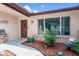 Inviting front entrance featuring a decorative garden bed and a well-maintained exterior at 7716 Vienna Ln, Port Richey, FL 34668