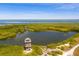 Panoramic aerial view of lush wetlands with viewing tower and clear blue ocean at 7912 Desoto Memorial Hwy, Bradenton, FL 34209