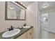 Bright bathroom featuring a double sink vanity with green marble counter and decorative mirror at 7912 Desoto Memorial Hwy, Bradenton, FL 34209
