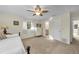 Cozy bedroom featuring neutral tones, a ceiling fan, a white dresser and a full bathroom at 7912 Desoto Memorial Hwy, Bradenton, FL 34209