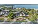 Stunning waterfront home with lush landscaping, circular driveway, and partial water views at 7912 Desoto Memorial Hwy, Bradenton, FL 34209