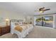 Serene main bedroom featuring a ceiling fan, a private balcony, and neutral decor at 7912 Desoto Memorial Hwy, Bradenton, FL 34209