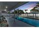 Relaxing pool area with cushioned seating, white fence, palm trees and nice sunset background at 7912 Desoto Memorial Hwy, Bradenton, FL 34209
