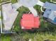 Aerial view of the house featuring the red roof, circular drive, mature trees, and landscaping at 9142 16Th Avenue Nw Cir, Bradenton, FL 34209