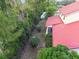 Rear view from above showing the yard, fence line, and red roof at 9142 16Th Avenue Nw Cir, Bradenton, FL 34209