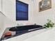 This bathtub features tile surround, blue accents, and a picture hanging on the wall at 9142 16Th Avenue Nw Cir, Bradenton, FL 34209