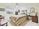 Bright bedroom featuring a ceiling fan, window views, and vintage furniture at 9142 16Th Avenue Nw Cir, Bradenton, FL 34209