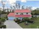 Charming two-story home with a red roof, lush lawn, and mature landscaping at 9142 16Th Avenue Nw Cir, Bradenton, FL 34209