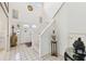 Bright foyer with tiled floor, staircase, and a decorative double-door entrance at 9142 16Th Avenue Nw Cir, Bradenton, FL 34209