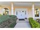 Inviting front entrance featuring a double-door entry, arched windows, and manicured shrubs at 9142 16Th Avenue Nw Cir, Bradenton, FL 34209