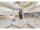 Bright kitchen features white cabinets, tile floors, an island and pink countertops at 9142 16Th Avenue Nw Cir, Bradenton, FL 34209