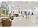 Expansive living room with large windows, plush seating, and a charming piano at 9142 16Th Avenue Nw Cir, Bradenton, FL 34209