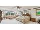 Spacious main bedroom featuring a ceiling fan, sitting area, and decorative wall art at 9142 16Th Avenue Nw Cir, Bradenton, FL 34209
