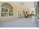 Relaxing covered patio with tile floor and large windows to the outdoor view at 9142 16Th Avenue Nw Cir, Bradenton, FL 34209