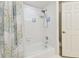 Shower and tub combo with white tile and accent tiles plus a swan print shower curtain at 9142 16Th Avenue Nw Cir, Bradenton, FL 34209