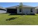 A backyard featuring a well-maintained lawn and a screened-in lanai at 2556 Averland Loop, North Port, FL 34287