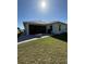 Backyard with brick pavers, a fire pit, and a view of the house and screened-in patio at 2556 Averland Loop, North Port, FL 34287