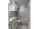 Bathroom with white cabinets, granite countertops, and a tub with a shower featuring a patterned curtain at 2556 Averland Loop, North Port, FL 34287