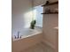 Bathroom featuring a soaking tub beneath a sunlit window at 2556 Averland Loop, North Port, FL 34287