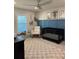 Stylish Bedroom featuring blue paneled walls, a black crib and a cozy white rocking chair at 2556 Averland Loop, North Port, FL 34287
