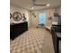 Well-lit Bedroom boasts a black dresser, a cozy rocking chair, and a light gray and cream checkered rug at 2556 Averland Loop, North Port, FL 34287