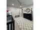 Cozy Bedroom features a black crib, dresser with round mirror and a light gray and cream checkered rug at 2556 Averland Loop, North Port, FL 34287