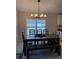 Dining room with modern chandelier, large window, and seating for six at 2556 Averland Loop, North Port, FL 34287