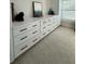Custom white dresser with black hardware, flanked by custom white storage at 2556 Averland Loop, North Port, FL 34287