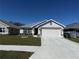 Charming single-Gathering home with a manicured lawn and a two-car garage, perfect for suburban living at 2556 Averland Loop, North Port, FL 34287