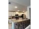 Modern kitchen with granite countertops, stainless steel appliances, white cabinetry, and a breakfast bar at 2556 Averland Loop, North Port, FL 34287