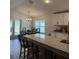 Kitchen with granite countertops, breakfast bar, and adjacent dining area with bench seating at 2556 Averland Loop, North Port, FL 34287