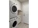 Laundry room with stacked washer/dryer, storage cabinets, and outside access door at 2556 Averland Loop, North Port, FL 34287