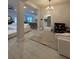 Open-concept living room with tile floors, neutral walls, and views of the kitchen and dining areas at 2556 Averland Loop, North Port, FL 34287