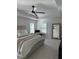 Bright main bedroom featuring a ceiling fan, plush carpet, and shuttered windows at 2556 Averland Loop, North Port, FL 34287