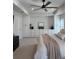 Bright and airy main bedroom boasting custom built-ins and a ceiling fan at 2556 Averland Loop, North Port, FL 34287