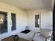 View of an enclosed back patio with a propane tank and furniture at 2556 Averland Loop, North Port, FL 34287
