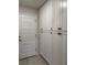 Hallway with extra tall storage cabinets and access to the garage at 2556 Averland Loop, North Port, FL 34287