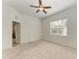 Bright bedroom with a ceiling fan, neutral carpet, and a large window at 11516 Griffith Park Ter, Bradenton, FL 34211