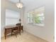 Bright home office with large windows, a wooden desk and chair, and tile flooring at 11516 Griffith Park Ter, Bradenton, FL 34211