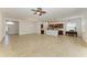 Expansive open living space with tile flooring, a ceiling fan, and a view into the kitchen and dining area at 11516 Griffith Park Ter, Bradenton, FL 34211