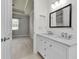 Bright bathroom boasts double sinks, quartz countertops, and modern fixtures, creating a serene and functional space at 13303 Swiftwater Way, Lakewood Ranch, FL 34211