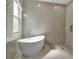 Bright bathroom with a modern tub and a spacious glass-enclosed shower for a relaxing experience at 13303 Swiftwater Way, Lakewood Ranch, FL 34211